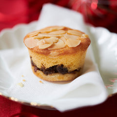 frangipane Mince pie with almonds on a white plate against a red background !