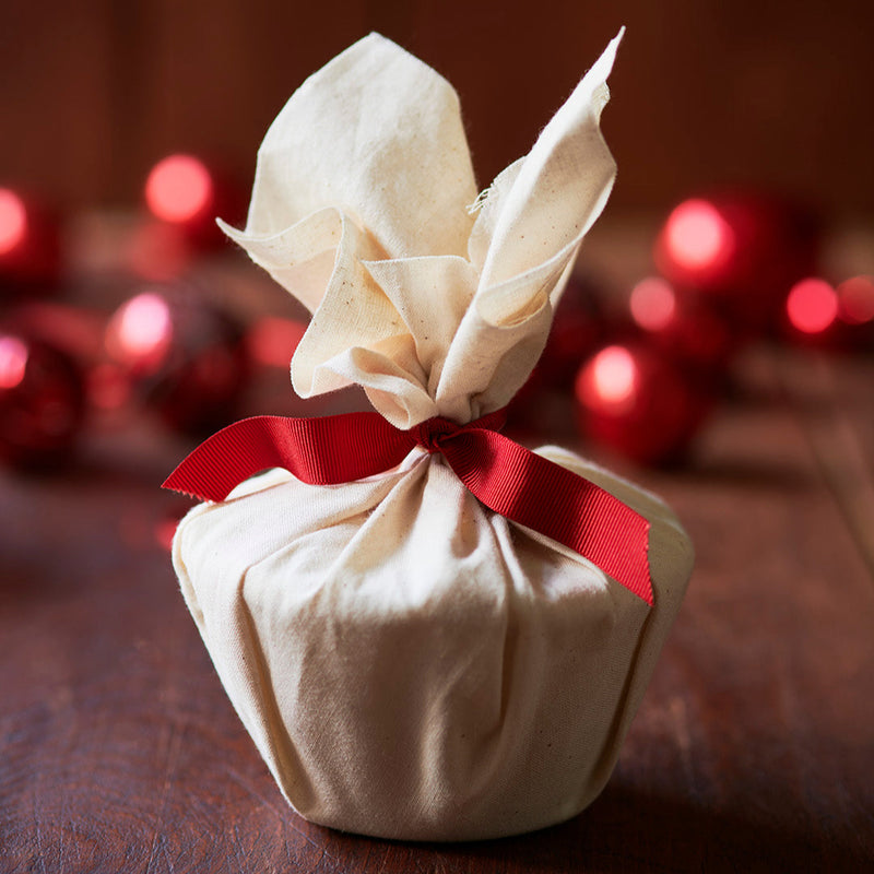 christmas pudding wrapped in calico with red ribbon tied on
